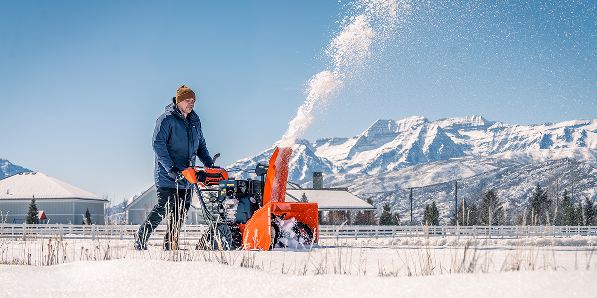 Ariens snow blower in front of mountain range