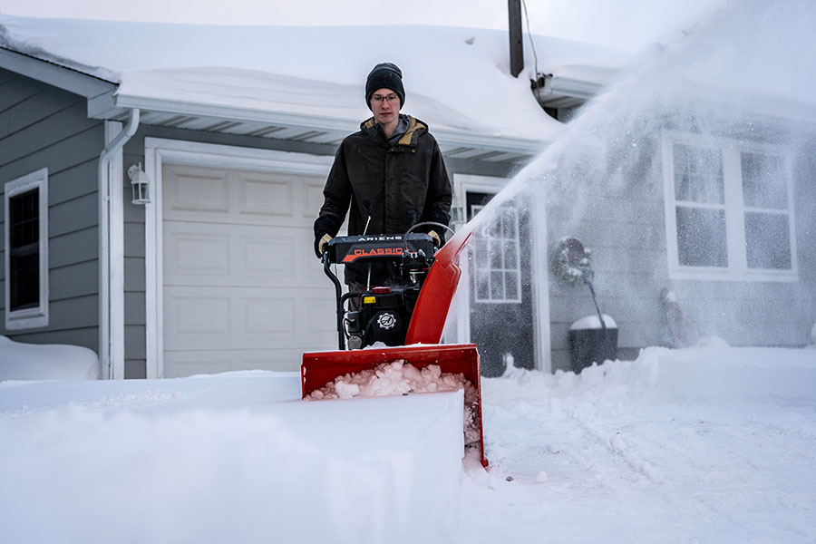 Ariens Classic snow blower removing heavy snow from a driveway